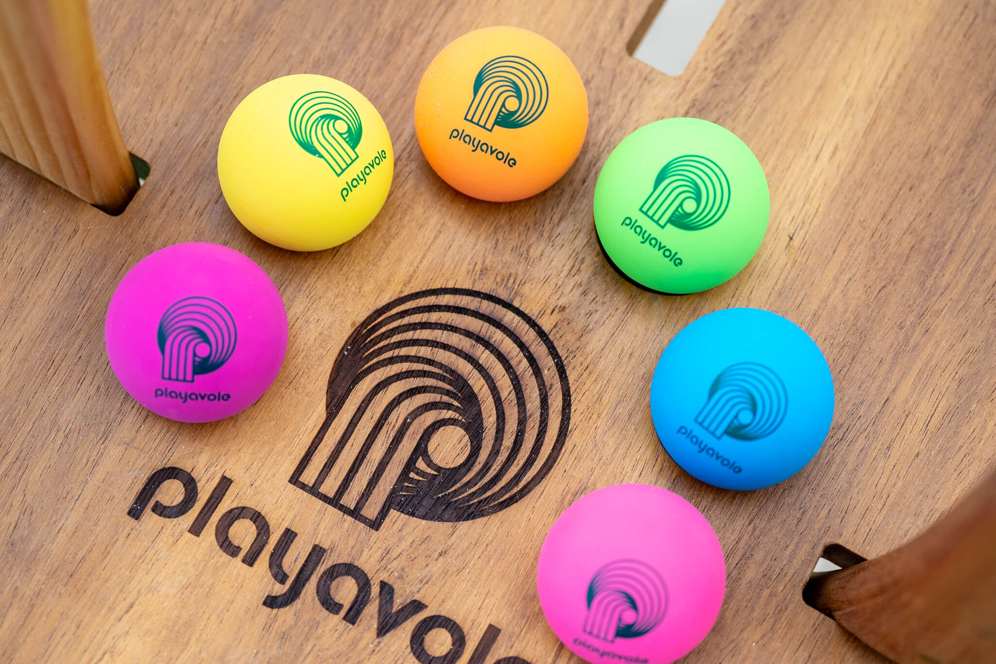 natural Vole Drops resting on teak Playa Table with teak Vole Paddles