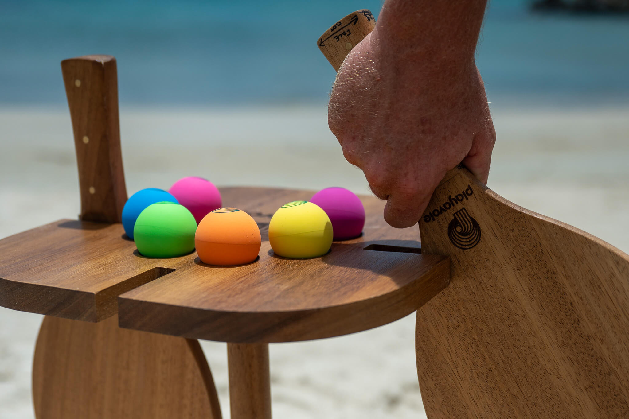 Close up view of the Playa Table and Vole Teak Drops with ocean 