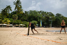 Player trying to return a drop in the game Rally on with teak paddle in the Rally Court